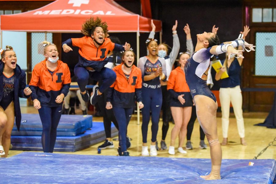 Junior Mia Townes jumps up in celebration with the rest of the team as fellow teammate junior Mia Takekawa sticks her landing during the competition against Rutgers on Feb. 25. Takekawa and Towne will be heading towards the NCAA Championships in Texas on April 14 to April 16. 