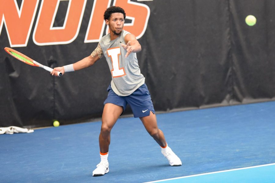 Redshirt junior Siphosothando Montsi eyes the ball during his doubles match against Baylor with partner graduate student Oliver Stuart on March 4. The Illini are about to wrap up their regular season this weekend with matches against Eastern Illinois, Indiana and Purdue. 