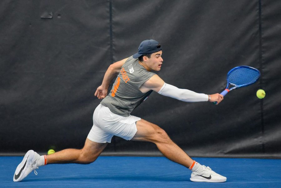 Graduate student Oliver Stuart reaches over to backhand the ball during his singles match against Purdue  for Senior Day on Sunday. The Illini will be heading towards Madison, Wisconsin to play against the Badgers for the Big Ten tournament quarterfinals on Friday. 