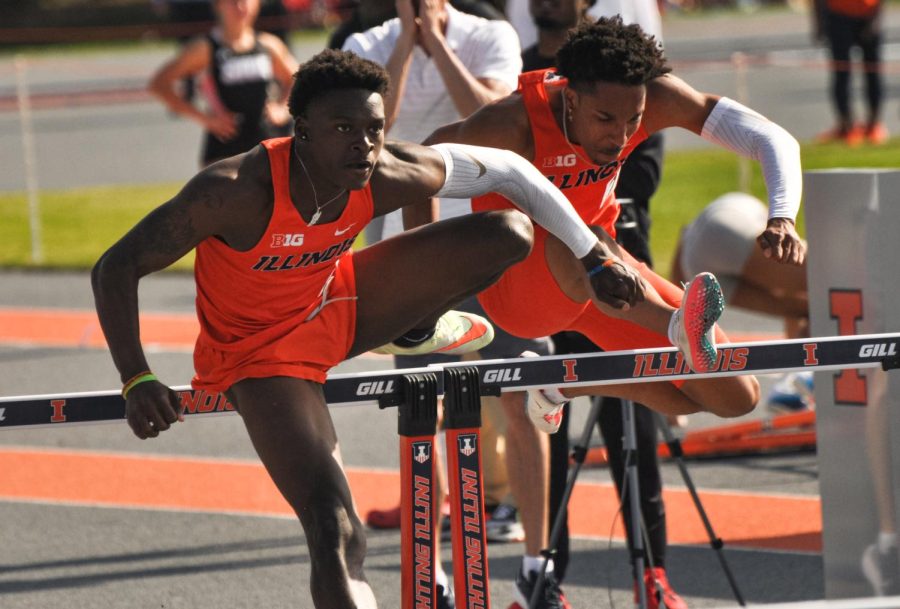 Freshman DeVontae Ford leaps over the hurdles alongside teammate junior Robert Williams during their 110 meter hurdles event for the Illini Invitational on Saturday. Ford placed third with 13.91 seconds and Williams placed eleventh with 14.66 during the 110 meter hurdles event. 