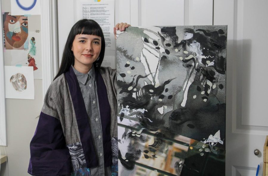 Artist Alice Yumi stands with one of her pieces of art at her studio on Friday. Yumi’s art is inspired by her Brazilian and Japanese culture while incorporating themes of identity and body. 