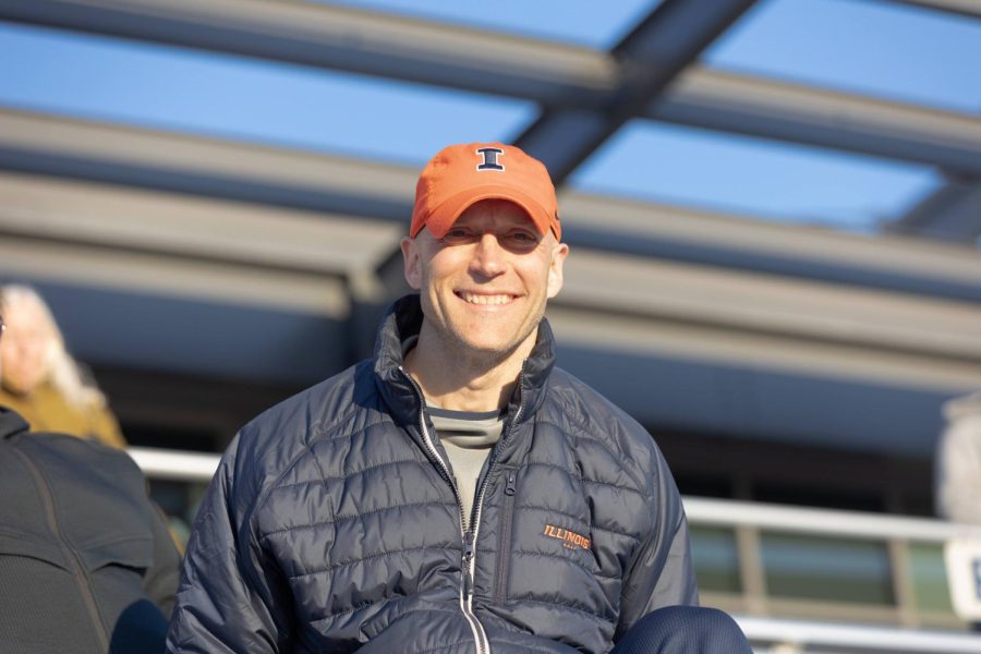 Athletics Director Josh Whitman sits on the bleachers during Illini Classic Track meet on April 9. Whitman recently released a statement that the University will have to suspend its consideration for the admission of I mens Hockey to Division I.