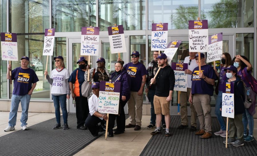Members of the Local 73 of the Service Employees International Union strike outside of the Ikenberry Commons on April 29. More than 50% of the Local 73 group has voted to approve a strike authorization due to no progression being made with negotiations with the University. 