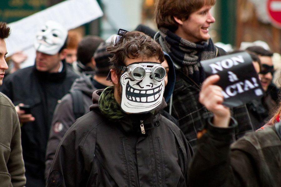 A+protester+wearing+a+troll+face+mask+during+the+anti+ACTA+protest+in+Paris+on+Feb.+25%2C+2012.+Opinions+editor+Aparna+Lakkaraju+argues+that+radical+terrorism+stem+from+online+forums+like+4chan.+