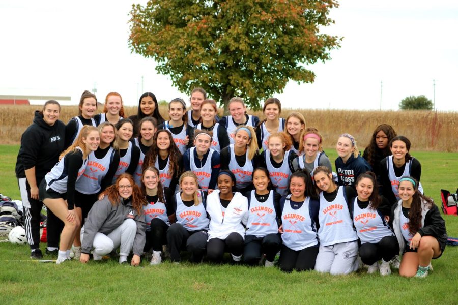 The Illinois womens lacrosse club huddle together for photo. The team is one of 38 registered club sports on campus. 