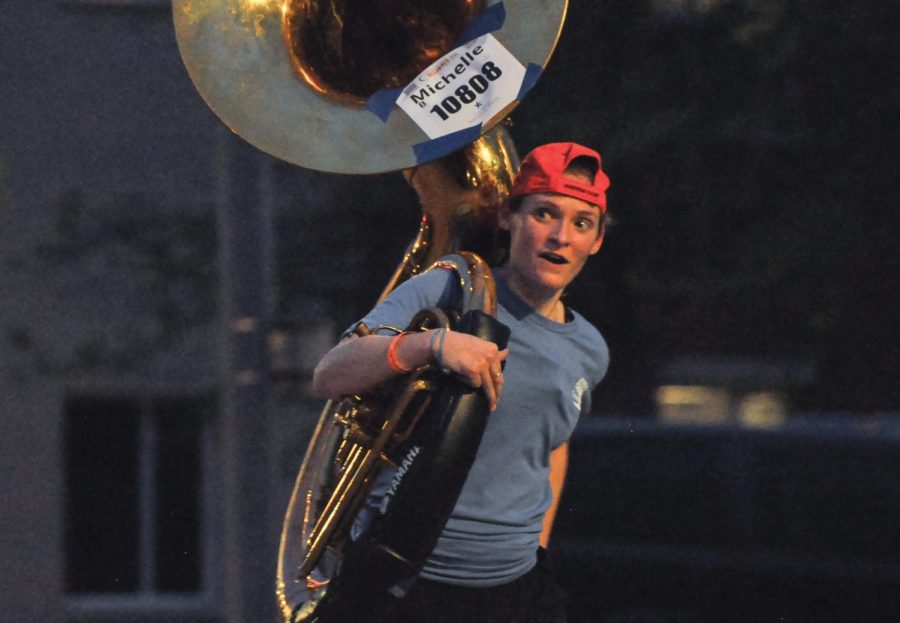 Michelle+Bell%2C+a+graduate+student+studying+wind+band+conducting%2C+runs+with+her+sousaphone+during+the+Illinois+5k+Marathon+on+Friday.+Around+30+Marching+Illini+sousaphone+players+participated+in+the+run.+%0A