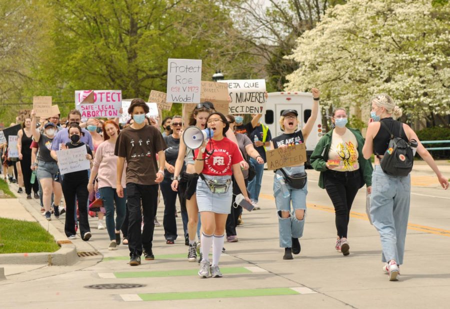 The front of the march begin to storm Green Street as they make their way towards the Champaign County Courthouse on May 8. 