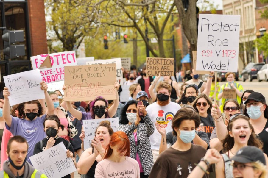 People march on the sidewalks of Springfield Avenue in downtown Urbana towards the Champaign County Courthouse during Amnesty’s Reproductive Rights Rally on May 8. Senior columnist Andrew Prozorovsky argues that the Supreme Court will be putting many people at risk if they are to overturn Roe v. Wade.