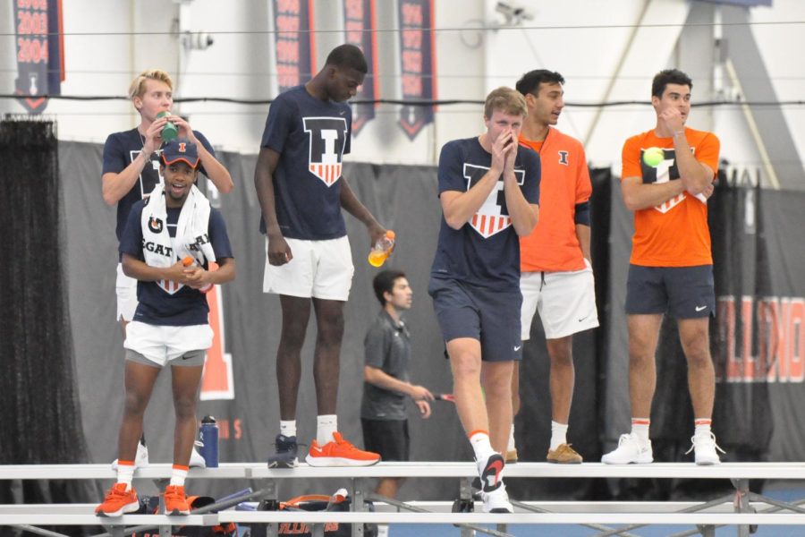 The+Illinois+men%E2%80%99s+tennis+team+cheers+on+from+the+sidelines+during+doubles+matches+against+Chicago+State+on+Jan.+23.+The+Illini+finished+the+season+14-14+and+among+the+top+four+in+Big+Ten.+
