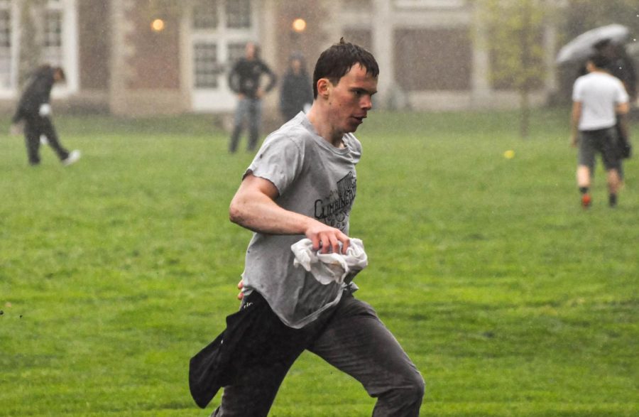 Ian Call, a senior in LAS, captures the flag scoring a second point for the white team during the campus wide capture the flag game on the South Quad on Thursday. The white team defeated the black team. 3-0. 