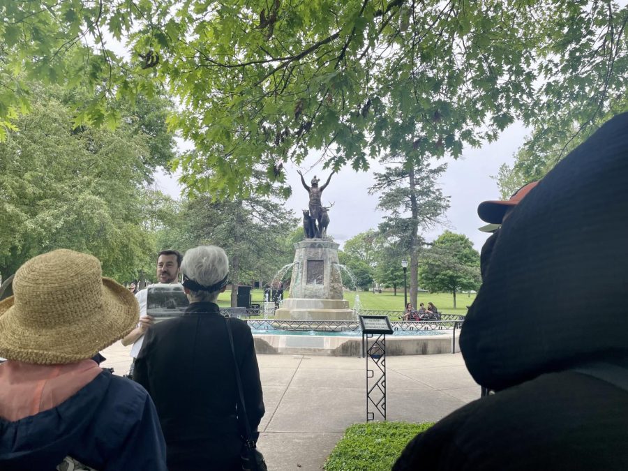  TJ Blakeman, the president of the board of trustees of the Champaign County History Museum, speaks in front of the Prayer for Rain Sculpture on Sunday. The museum has brought back their tours around downtown Champaign featuring a variety of historic sites and landmarks. 