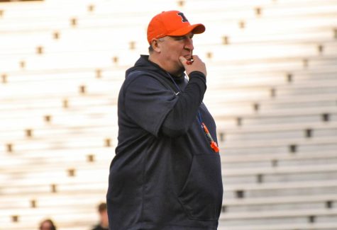 Illinois football head coach head coach Bret Bielema watches the team warm up before the Spring Orange and Blue game on April 21. Nine recruits have visited Illinois in meeting with coaching staff, and the team currently have 11 commits. 