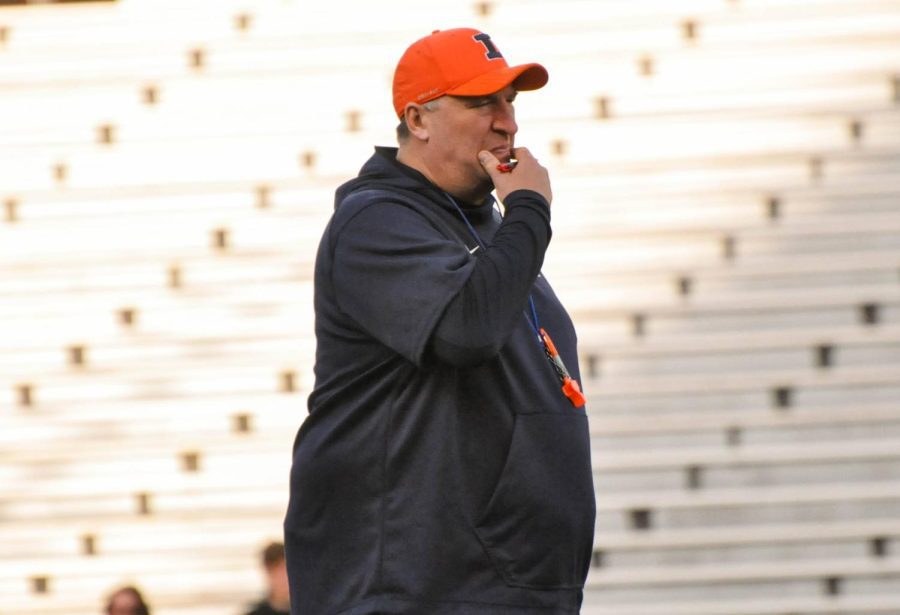 Illinois football head coach head coach Bret Bielema watches the team warm up before the Spring Orange and Blue game on April 21. Nine recruits have visited Illinois in meeting with coaching staff, and the team currently have 11 commits. 