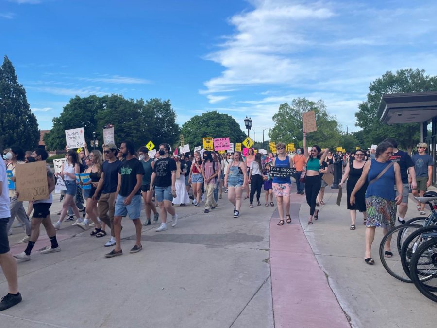 Protesters march towards the Champaign County Courthouse with signs to fight against the overturning of Roe v. Wade on Friday. Assistant opinions editor Talia Duffy argues that Supreme Court overturning Roe v. Wade has caused many to lose respect for the system. 