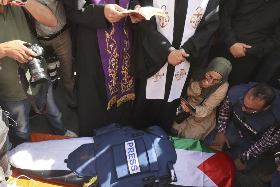 Priests and friends mourn over the body of Al Jazeera Palestinian journalist, Shireen Abu Akleh, on May 11 before her body is transferred for burial from a hospital in Jenin. Abu Akleh was shot dead as she covered an Israeli army raid on the West Banks Jenin refugee camp. 