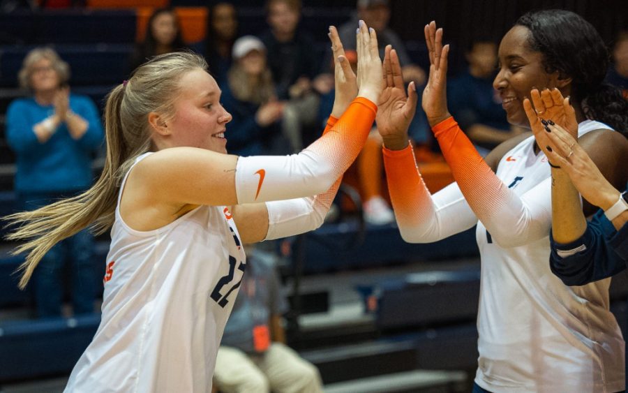 Freshman setter Brooke Mosher high fives senior middle blocker Kennedy Collins during the scrimmage against 
Brøndby Volleyball Klub on March 9. The team will be adding four new faces: outside hitter Sophie Stevenson, outside hitter Kayla Burbage, middle blocker Cari Bohm and setter Bianca May. 