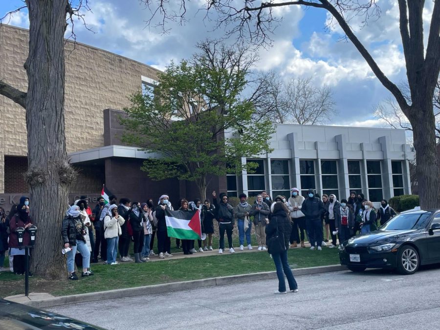 The Students for Justice in Palestine protest outside of the Hillel on April 18. A UI graduate has been charged with committing a hate crime for allegedly throwing a rock at students on the patio of the Hillel during the protest. 