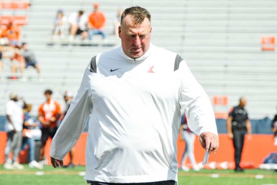 Illinois football head coach Bret Bielema walks on the field before the kickoff against Wyoming on Saturday. 