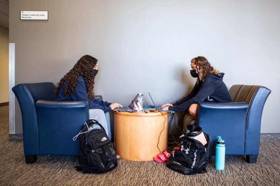 Students wearing masks sit at a distance in the Ikenberry Commons doing school work on Sept. 18. More students this upcoming school year will experience a more normal school year with the mask mandate lifted and building access regulations. 