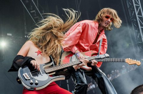 Victoria De Angelis headbangs on stage next to Thomas Raggi during Måneskins set for Lollapalooza on Sunday.