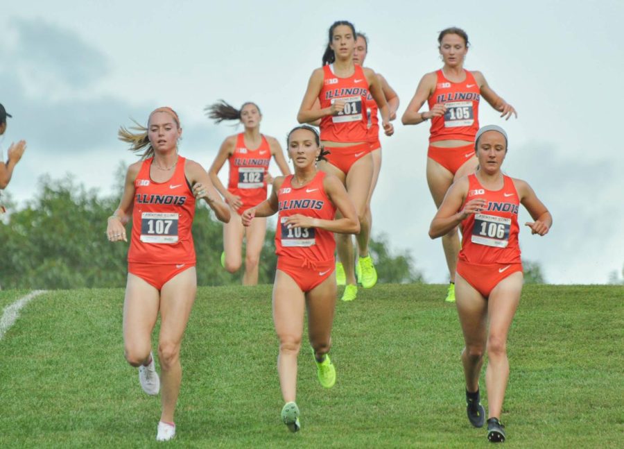 The Illinois womens cross country team runs down a hill during their first lap around the Universitys Arboretum for the Illini Challenge against Illinois State on Sept. 1. The Illini will be heading to Indiana State for the John McNichols Cross-Country Invitational on Saturday. 