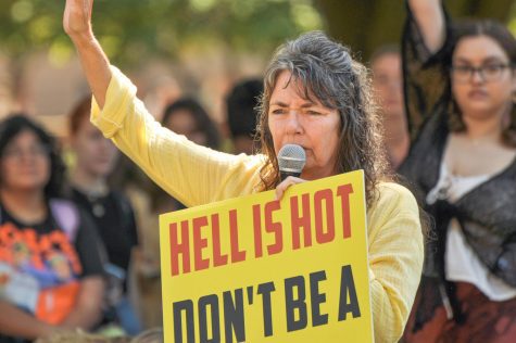 Sister Cindy preaches on the Main Quad holding a sign, Hell is hot dont be a T.H.O.T, on Thursday. Sister Cindy visited the campus exactly a year ago on Sept. 8. 