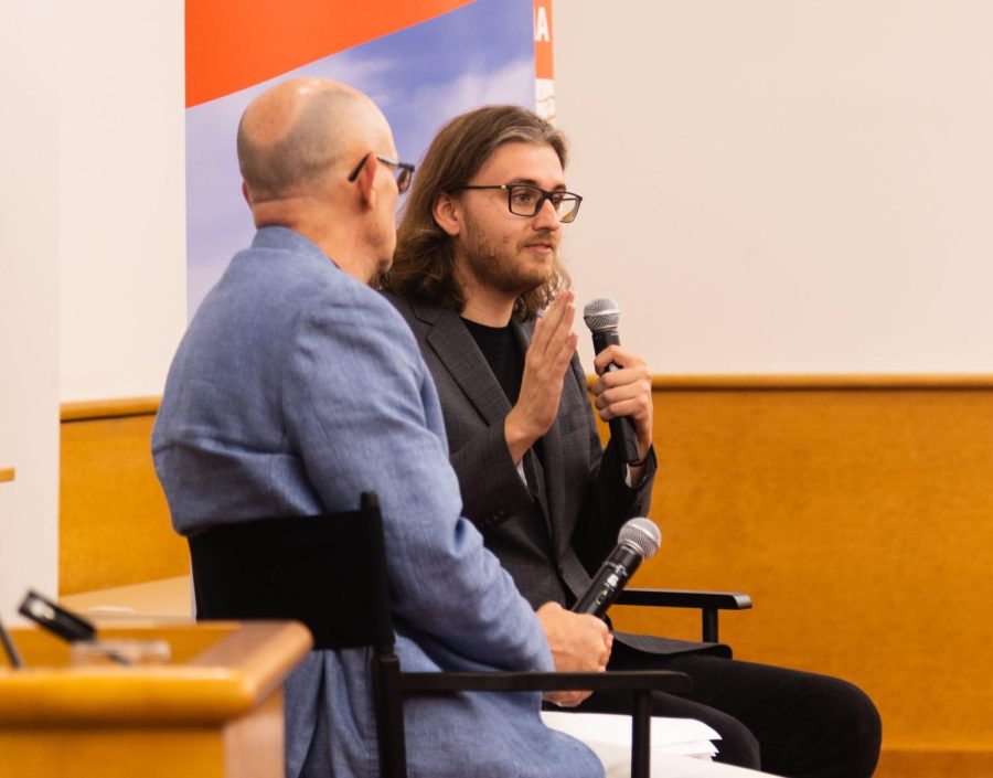 Journalist Eli Murray sits next to Charles Ledford, associate professor of journalism, as he answers questions during a Q&A in the ACES Funk Library on Thursday. Earlier this year Murray won a Pulitzer Prize for Investigative Journalism. 