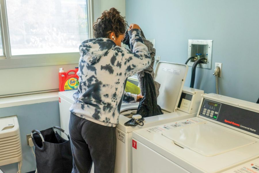 Mahi Patel, freshman in LAS, does her laundry in Hopkins Hall on Saturday. 
