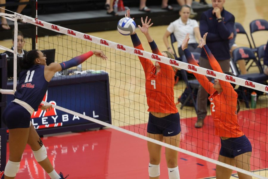 Sophomore outside hitter Kayla Burbage (9) and senior middle blocker Rylee Hinton (2) jump to block the ball during the match against Ole Miss on Aug. 28. The Illini will be up against Missouri State on Friday. 