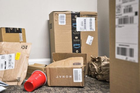 Damaged packages and trash are scattered around the mailroom at one of the apartment complexes on Euclid Street on Thursday. 
