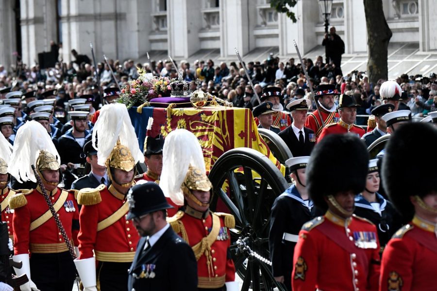 The coffin of Queen Elizabeth II, draped in the Royal Standard, rests on the State Gun Carriage as the funeral procession proceeds from Westminster Abbey to Wellington Arch on Sept. 19. 