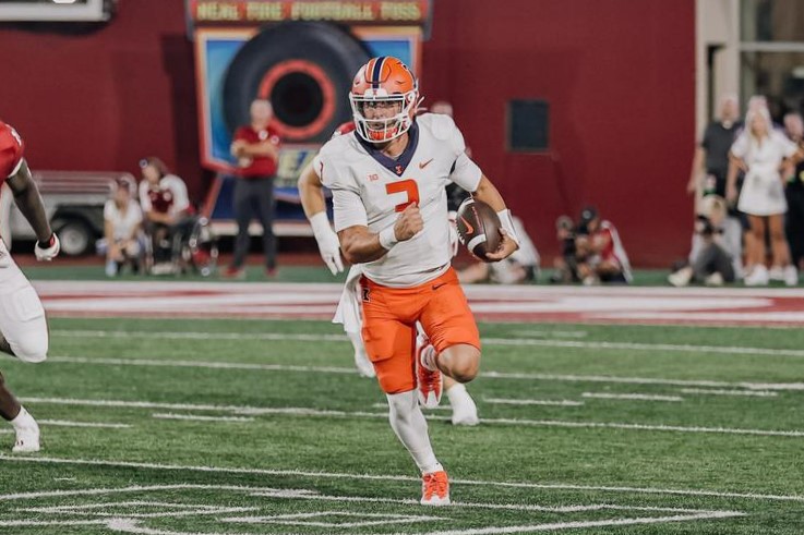 Senior quarterback Tommy DeVito runs the ball during the game against Indiana on Friday. The Illini fall against Indiana 23-20. 