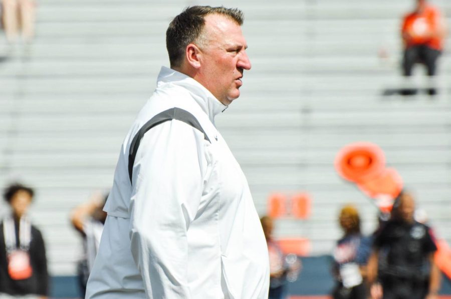 Illinois football head coach Bret Bielema watches the team warm up before the game against Wyoming on Aug. 27. 