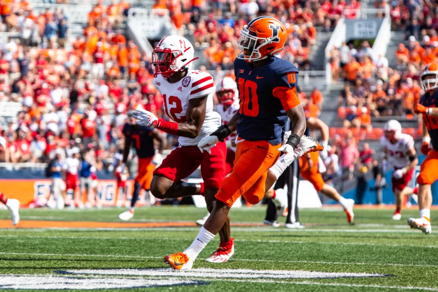 Wide receiver Desmond Dan Jr. prepares for a pass as Marques Buford Jr., defensive back for Nebraska, prepares to intercept during a match on Aug. 28, 2021. The Daily Illini Podcast alongside SBNation beat writer Jon Johnston discuss and predict the Illinis and Nebraskas faceoff this season happening today.