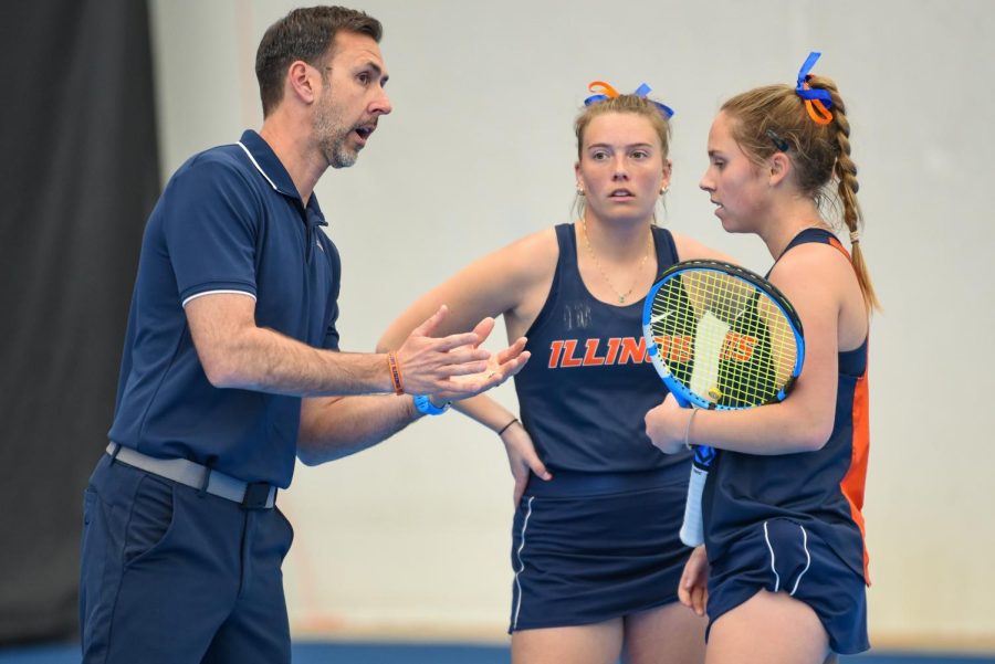 Associate head coach German Dalmargo speaks with doubles partners senior Emily Casati (middle) and sophomore Lasia Treiber during their match against Rutgers on March 27. 