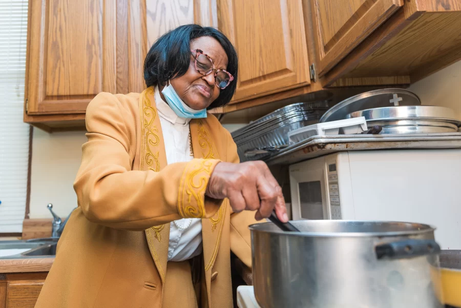 Reverend Evelyn Underwood spends time preparing food for the congregation and charity on Sunday. Dr. Underwood is an associate minister at the New Will Free Baptist Church. 