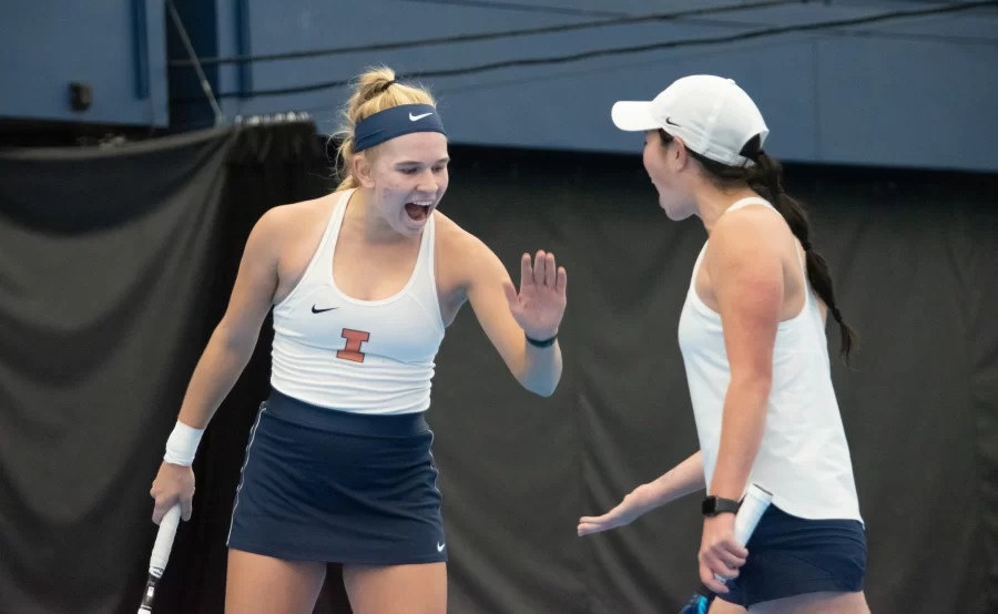 Sophomore Megan Heuser and Junior Kate Duong celebrate a great doubles performance on Feb. 6. In a collective effort, Duong and Heuser won the double draws at Michigans ITA Midwest Regionals, earning the duo placement in the ITA National Championships.
