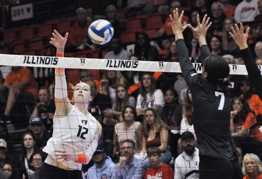 Junior outside hitter Raina Terry hits the ball over the net as Northwestern tries to block on Sept. 24. 