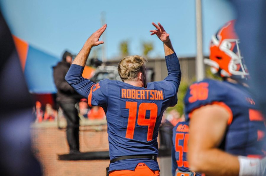 Redshirt freshman punter Hugh Robertson pumps up the crowd on the sidelines on October 17, 2022. Robertson spoke about his love of food and football during on-campus media day. 
