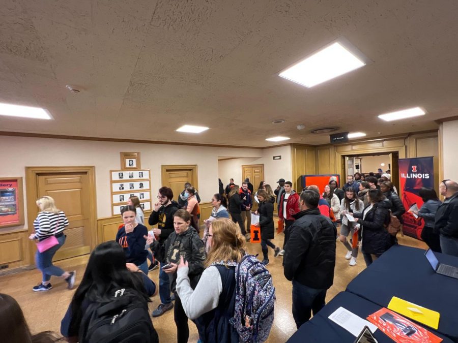 People evacuate the Illini Union as the alarms sound off on Friday.  