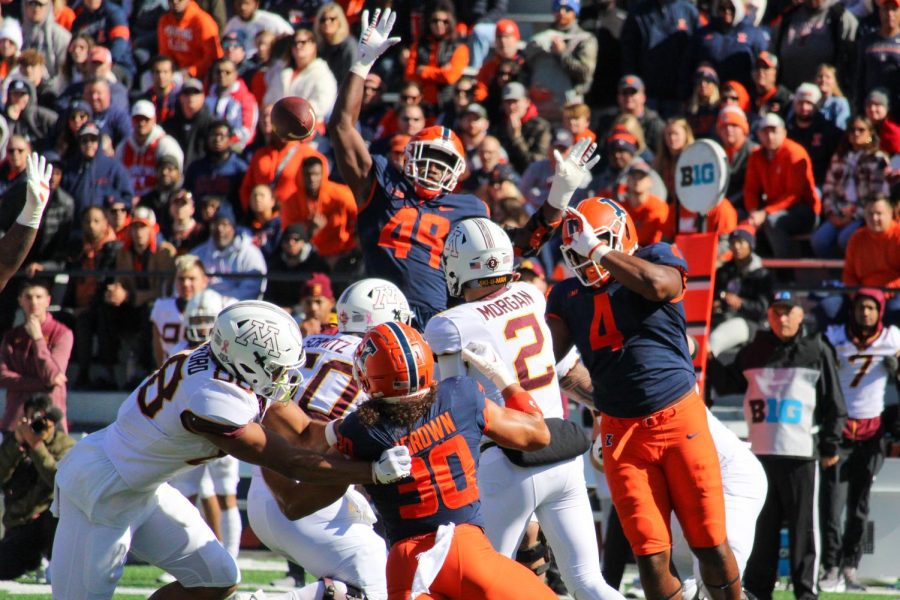Illinois defense swarms the Minnesota quarterback on Saturday during the 26-14 win.