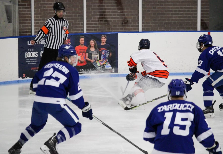 Forward Jack Kolb attempts to shake off Grand Valley State as the team locks in on him on Oct. 23. Students express interest over Illini Hockeys goal to become an official division 1 sport at the University of Illinois.