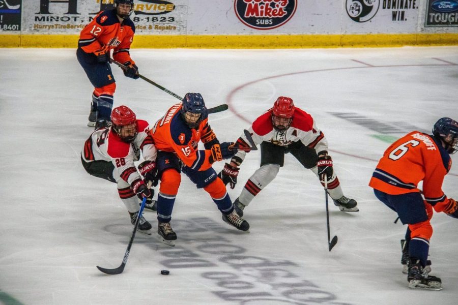 The Illini face off against opposing players at the center of the rink. The team suffered an 0-8 defeat  on Saturday against Ohio. 