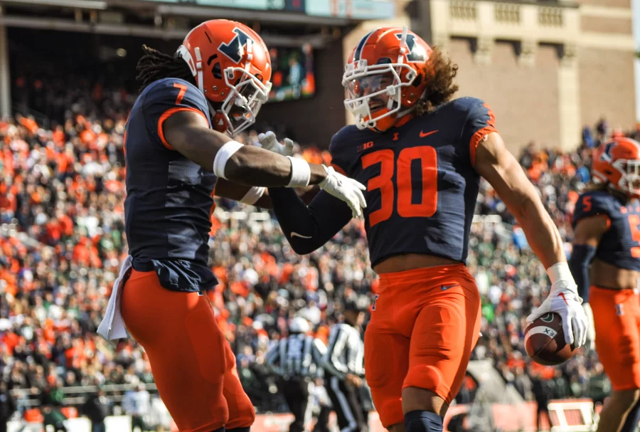 Senior defensive backs Sydney Brown (30) and Kendall Smith (7) celebrate Browns interception during the first quarter against Michigan State on Saturday.