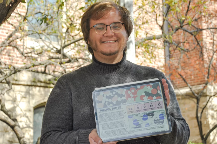 Jorge Calderin, graduate student studying biochemistry, with his iPad that he uses to doodle and write his notes with. Calderin shares his content with 411k followers on his Instagram @doodlesinthemembrane. 