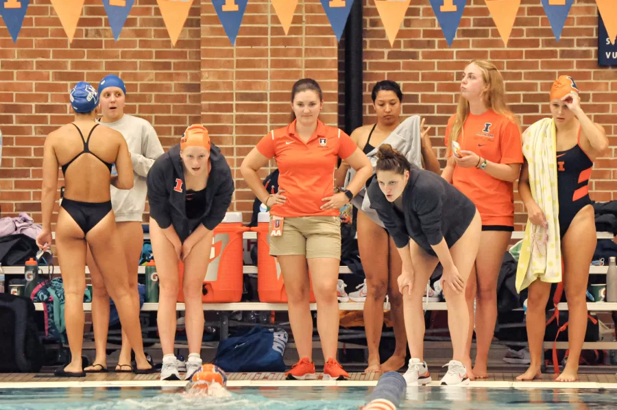 The Illinois swim and dive team cheer on their teammates during their home meet against Indiana State on Oct. 8. 