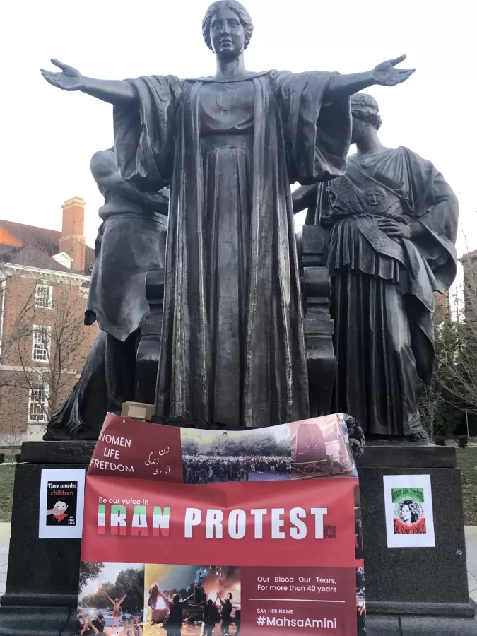 Alma Mater wrapped with a banner protesting the Iranian regime during the rally on Nov. 30.