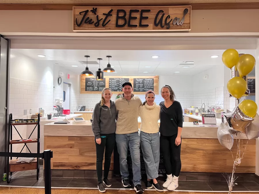 Current Just BEE Açaí owner Kristin Reinbold (pictured in white) with her husband, Norman Reinbold, and two employees at the store front. The store in located inside the Illini Union.
