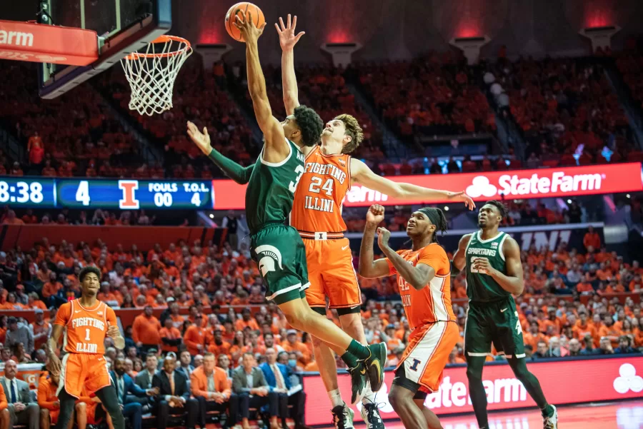 Fifth-year+forward+Matthew+Mayer+attempts+to+block+a+layup+against+Michigan+State+on+Friday.+Mayers+performance+contributed+to+a+75-66+Illini+victory.
