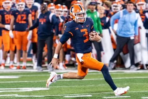 Quarter back Tommy DeVito runs down the field for a touchdown against Iowa on Oct. 8.
The Illini will be making their returning debut for the ReliaQuest Bowl this Monday against Mississippi State.